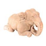 An Indian terracotta elephant, late 19th or early 20th century, modelled kneeling, 33cm high x