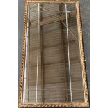 A gilt framed mirror with engraved plate detail, 96x50