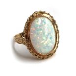 A 9ct gold ring set with a synthetic opal cabochon, size R 1/2, 5.4g