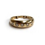 A 9ct gold gypsy ring set with five diamonds, resizing dots, size M, 2.3g