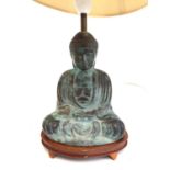 A bronze buddha in the form of a lamp on wooden stand, the buddha 17cmH