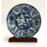 An OKA blue and white Kraak plate, 25.5cmD; on a hardwood stand