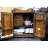 A Victorian oak smokers cabinet, fitted interior with contents including a Doulton style tobacco