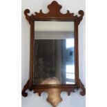 An 18th century style fret carved mirror, 62x36cm