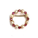 A 9ct gold brooch set with rubies and pearls, 2.7g