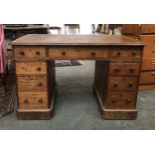 A Victorian oak pedestal desk, the traditional arrangement of nine drawers, on plinth bases,