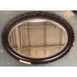 An oval wall mirror, 86x62cm