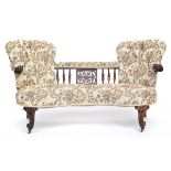 A Victorian beech framed and walnut double ended button back sofa, with carved arms, and central