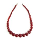A cherry amber bakelite type bead necklace, the largest bead 2.6cmD, 116g