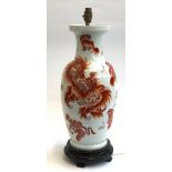 A modern Chinese table lamp of baluster form decorated with foo dogs on a white ground, 59cmH