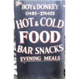 An advertising sign 'The Boy & Donkey, hot and cold food and bar snacks, 107x65cm
