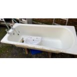 An enamel bath, together with a cloakroom basin