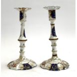 A pair of 18th century South Staffordshire, likely Bilston, enamel candlesticks (af), decorated in