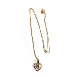 A 9ct gold necklace with a yellow and white gold heart pendant set with three diamonds, the chain