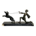An Art deco style spelter figure of a person with two long dogs, base 53cmL