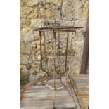 Two pieces of decorative metal work, together with 2 wrought iron plant stands