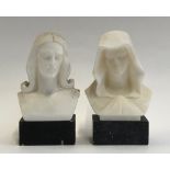 An Italian carved marble bust of Jesus; together with one of Mary, each on black marble plinths,