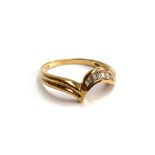 An 18ct gold ring with channel set baguette cut diamonds, size O 1/2, 2.7g