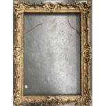 A large gilt gesso picture frame with pierced scrolls and shell decoration, internal dimensions