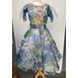 A 1950s blue and green nylon 'A' line dress with attached underskirt (size approx 36" bust),