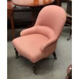 A small beech framed Victorian slipper chair, on turned legs and brass caps with ceramics casters,