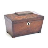 A Regency mahogany sarcophagus tea caddy, the lid with central gadrooned tablet