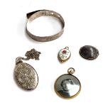 A silver engraved bangle, 15g; together with a gilt metal photo locket; silver and montrose agate