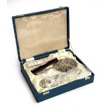 A cased silver backed four piece dressing table set, Birmingham, 1985, comprising two brushes, comb,