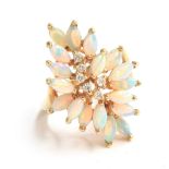A 14ct gold modernist dress ring set with 18 marquise cut opals surrounding diamonds, size M 1/2,
