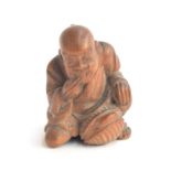 A Japanese boxwood netsuke of a kneeling man, 3.5cm high Provenance: the Peto Family, formerly of