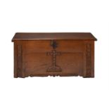 An 18th century carved oak coffer in Ecclesiastical taste, the front carved with stylised cross,