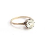 An early 20th century white gold solitaire ring set with a white zircon, approx. 1.5ct, size J 1/