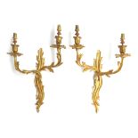 A pair of gilt metal wall sconces of foliate form, 48cm high Provenance: Formerly part of the