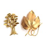 A 9ct gold brooch in the form of a vine leaf, 3cm long, 2.3g; together with a 9ct gold tree