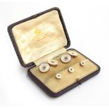 A cased set of Asprey 9ct gold and mother of pearl button style cufflinks and studs, gross weight