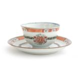 A Chinese teacup and saucer, floral decoration with orange rim, heightened in gilt, the cup 7.5cm