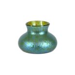 An Art Nouveau iridescent green glass vase of compressed form and of Loetz type, 9cm high