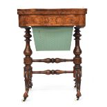 A 19th century burr walnut and marquetry games and work table, the shaped foldover top opening to