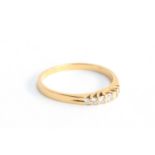 An 18ct gold ring set with seven brilliant cut diamonds, size O, 2.1g