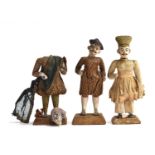 Three late 19th century Indian clay figures of men, in material clothing, some losses, each on a