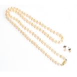 A long cultured pearl single strand necklace, with 14ct gold clasp, 72cm long; together with a