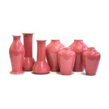 Seven various Ault pottery pink glazed vases, 21.5cm to 32cm high