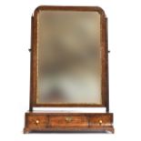 A George II walnut dressing mirror, the plate within a gilt slip, over a base of three drawers on