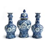 A pair of late 18th/early 19th century Delft vases of lobed tapering form, with alternating hand