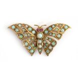 A 9ct gold brooch in the form of a butterfly set with opals and ruby eyes, approx. 5.4g