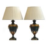 A pair of decorative toleware table lamps, in the form of urns, with gilt oak leaf and acanthus