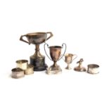 A mixed lot of various silver items, to include several twin handled trophy cups, four napkin rings,