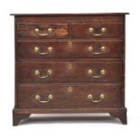 An early 18th century oak chest of two short over three graduating drawers, on bracket feet, cut