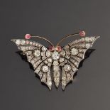 An exquisite Victorian diamond butterfly brooch, set in gold and silver with ruby eyes and antennae,