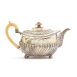 A George III silver teapot by Thomas Robins, London 1814, of rectangular form with half gadrooned